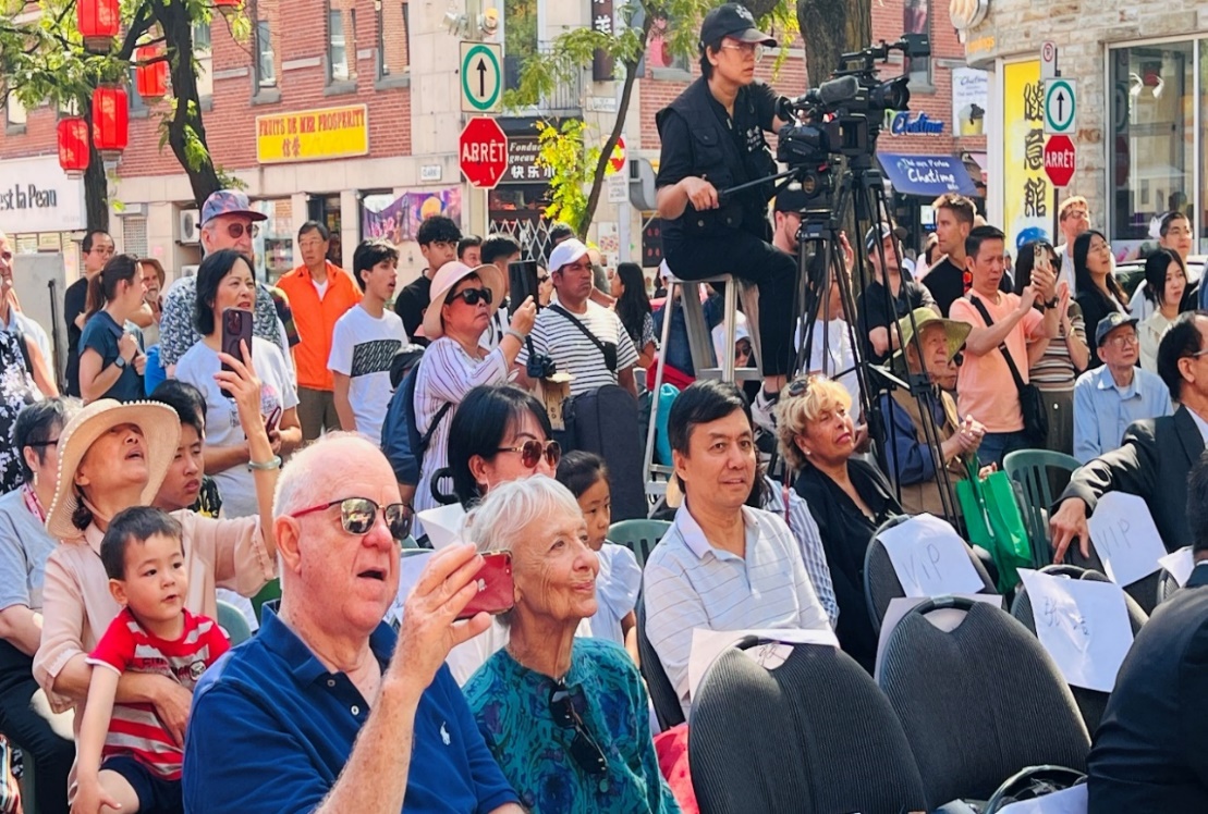 A group of people sitting in a crowd Description automatically generated